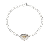 Sterling silver bracelet with a aspen leaf shaped pendant featuring a 14k yellow gold tiny Bear on a white background