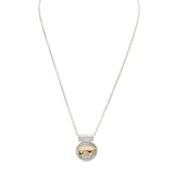 Necklace with a sterling silver heavy round pendant featuring a 14ky gold bear