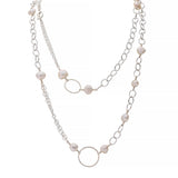 Necklace with pearls and mixed styles of sterling silver chain on a white background
