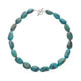 Turquoise beaded necklace with a silver clasp on a white background