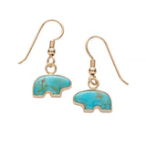 Turquoise stone bear earrings with gold accents on a white background