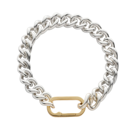 Thick silver chain bracelet with a oval hinge gold clasp on a white background