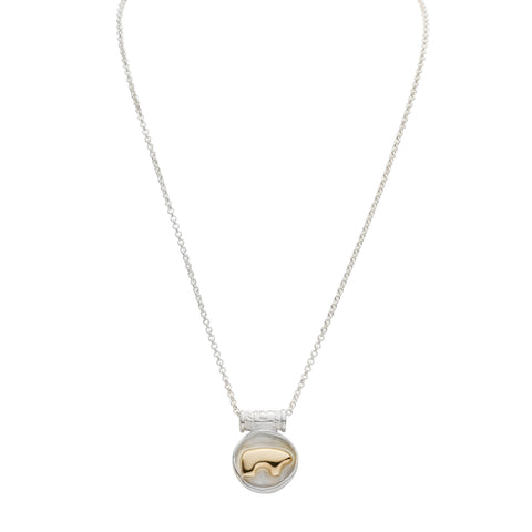 Necklace with a sterling silver heavy round pendant featuring a 14ky gold bear