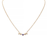 14k yellow gold kissing bear pendant with a lapis gemstone on a white background