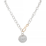 Silver necklace with a organic round pendant featuring an bear design on a white background