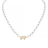 Sterling silver necklace with a gold bear charm on a white background
