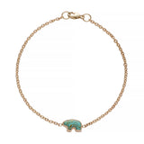 Gold bracelet with a turquoise bear  charm on a white background