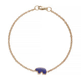 Gold bracelet with a blue lapis bear charm on a white background