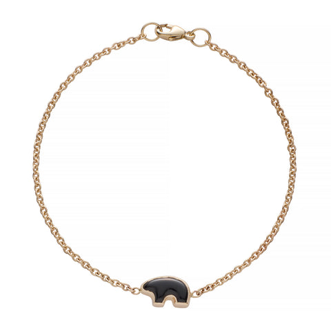 Gold bracelet with a onyx bear charm on a white background