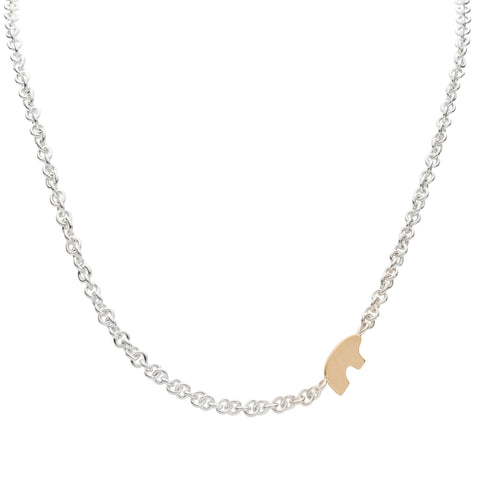 Necklace with a flat gold bear pendant on a white background