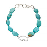 Turquoise beaded bracelet with a silver bear charm on a white background