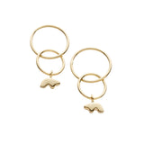 Interlocked gold hoop earrings with small  charm dangling on a white background