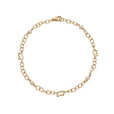 Gold chain bracelet with silhouette bears and small pearls on a white background