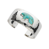 Silver cuff hand hammered cuff bracelet with turquoise stone  bear on a white background