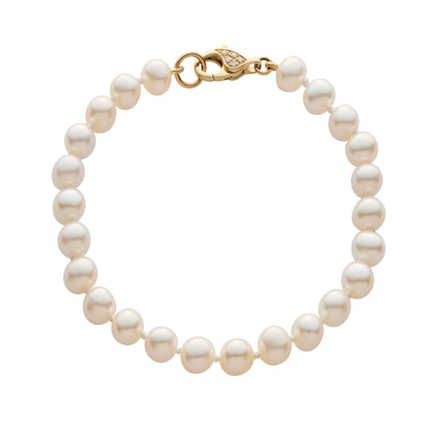 Pearl bracelet with pave diamond gold clasp on a white background
