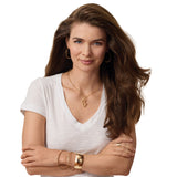 Woman wearing a white shirt and gold jewelry on a white background